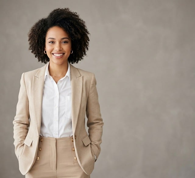 Professional headshot of a career coach giving advice on job search after industrial training, with a laptop showing a resume